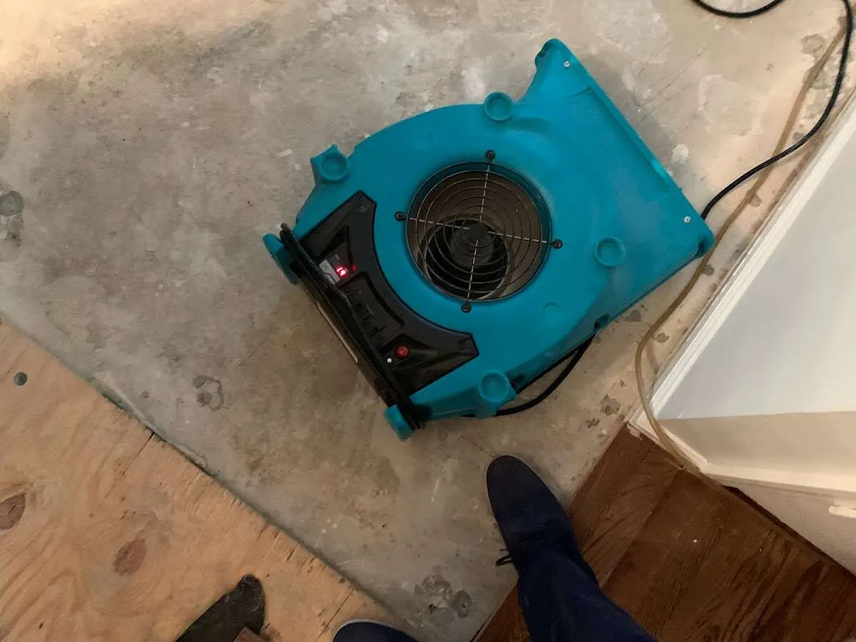 Air mover drying subfloor during Commercial Water Damage Restoration in New Hartford